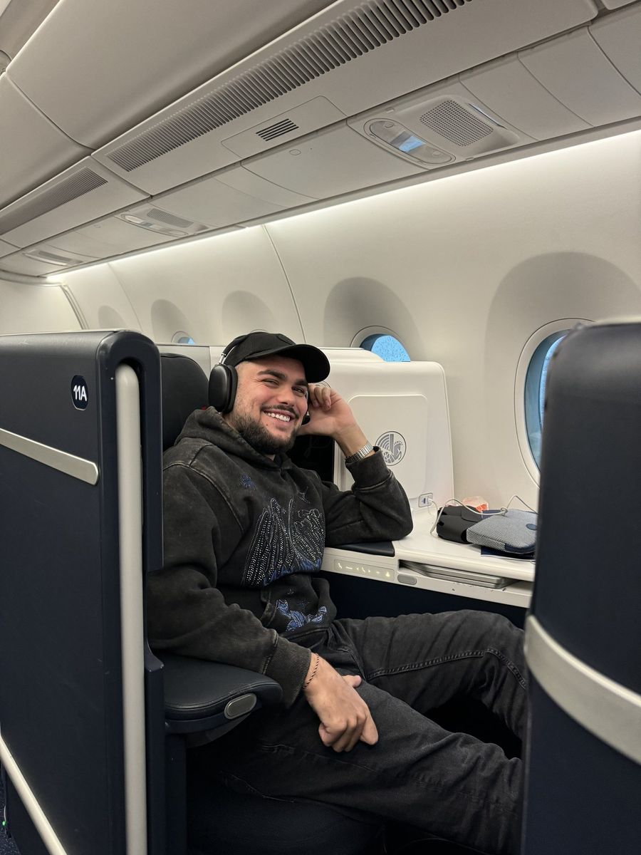 Passager casquette et casque audio installé au siège 11A de la nouvelle classe affaires long-courrier d'Air France